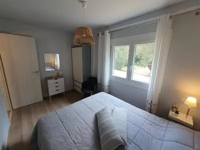 a bedroom with a large bed and a window at Jasmine Villa in Vari