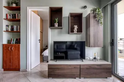 a living room with a couch and a fireplace at Sunny & cosy apt with balcony in Peristeri! in Athens