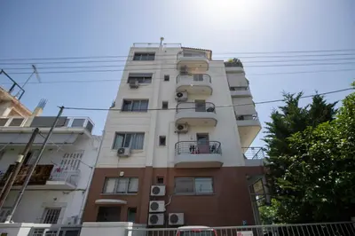 a tall building with balconies on the side of it at Sunny & cosy apt with balcony in Peristeri! in Athens