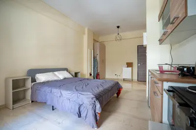 a bedroom with a bed in the middle of a room at Studio Ag Ioannis m station 1 bed 2 pers by MPS in Athens