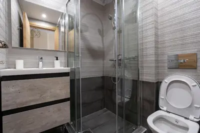 a bathroom with a toilet and a glass shower at Studio Ag Ioannis m station 1 bed 2 pers by MPS in Athens