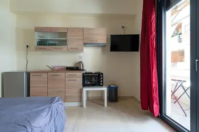 a small kitchen with a small table and a microwave at Studio Ag Ioannis m station 1 bed 2 pers by MPS in Athens