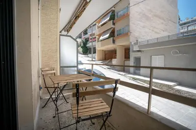 a balcony with tables and chairs on a building at Studio Ag Ioannis m station 1 bed 2 pers by MPS in Athens