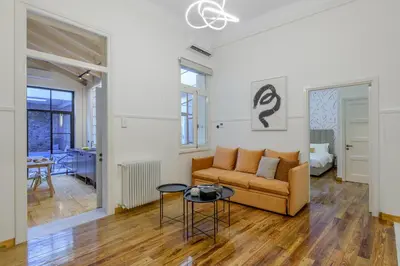 a living room with a couch and a table at Incomparable Plaka's Luxury Apt Private Pool in Athens