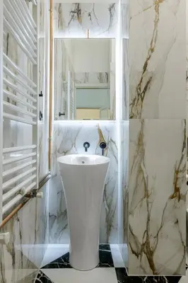 a bathroom with a white toilet and a sink at Incomparable Plaka's Luxury Apt Private Pool in Athens