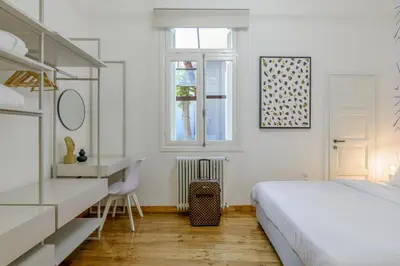 a white bedroom with a bed and a desk at Incomparable Plaka's Luxury Apt Private Pool in Athens