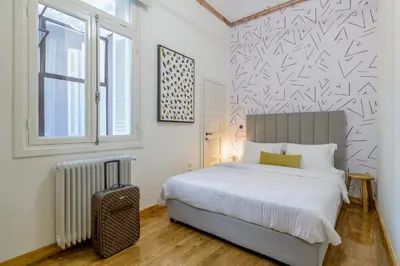 a bedroom with a bed and a window and a radiator at Incomparable Plaka's Luxury Apt Private Pool in Athens