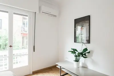 a living room with a table and a window at Elegant 2 Bedroom 2 Bathroom Apartment in Athens Vibrant Centre! VL5 in Athens