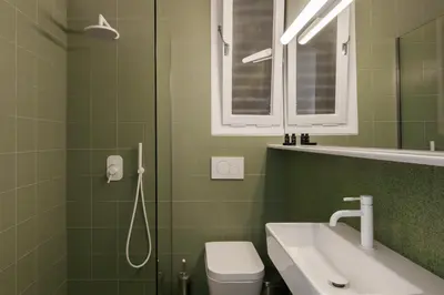 a bathroom with a sink and a toilet and a mirror at Elegant 2 Bedroom 2 Bathroom Apartment in Athens Vibrant Centre! VL5 in Athens
