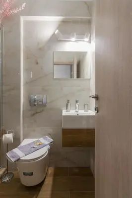 a bathroom with a toilet and a sink at Aphrodite Apartment in Athens
