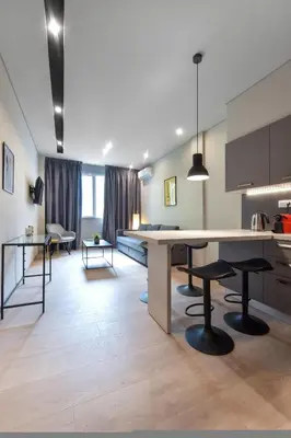 a kitchen and living room with a large table and chairs at Porto Pireo By SuperHost365 Kolokotroni in Piraeus