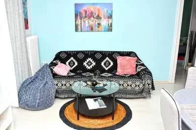 a living room with a couch and a table at Koukaki sunshine roof apartment in Athens