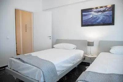 a bedroom with two beds and a lamp on a table at Marianna's Stylish Brand New Apt in the heart of Athens in Athens