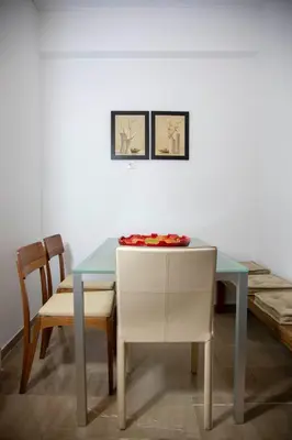 a dining room table with two chairs and a plate on it at Marianna's Stylish Brand New Apt in the heart of Athens in Athens