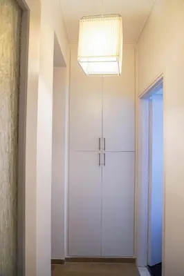 a room with a white door and a chandelier at Marianna's Stylish Brand New Apt in the heart of Athens in Athens