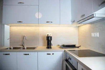 a kitchen with a sink and a coffee maker on the counter at Marianna's Stylish Brand New Apt in the heart of Athens in Athens
