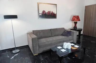 a living room with a couch and a table at Marianna's Stylish Brand New Apt in the heart of Athens in Athens