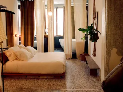a bedroom with a bed and a bathroom with a tub at Mona Athens in Athens