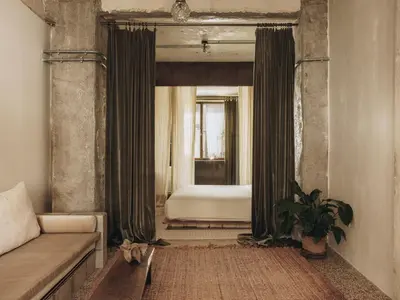 a living room with a couch and a bed at Mona Athens in Athens