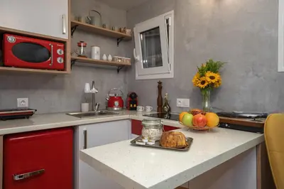 a kitchen with a counter with a plate of fruit on it at Cozy tiny apartment in the heart of Plaka in Athens