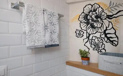 a bathroom with a mural of a flower on the wall at Cozy tiny apartment in the heart of Plaka in Athens
