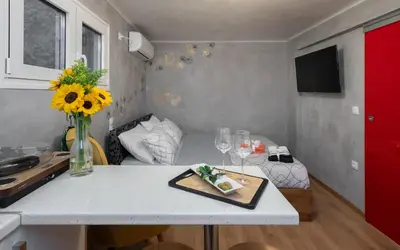 a kitchen with a table with a plate of food on it at Cozy tiny apartment in the heart of Plaka in Athens