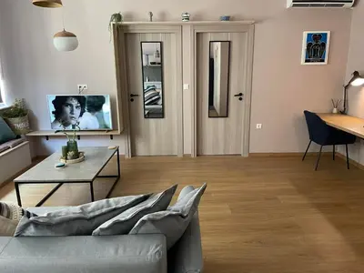 a living room with a couch and a table and a tv at Athens Historical Centre 2 Bedroom Apt. in Athens