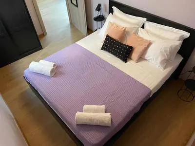 a large bed with two towels and pillows on it at Athens Historical Centre 2 Bedroom Apt. in Athens