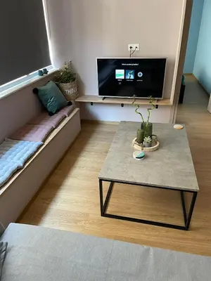 a living room with a coffee table and a flat screen tv at Athens Historical Centre 2 Bedroom Apt. in Athens