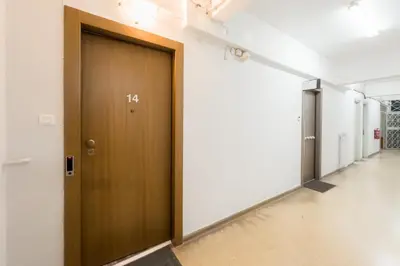 a hallway with a wooden door in a building at Athenian Dream Suite in Athens