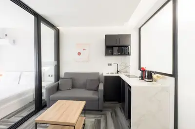 a living room with a couch and a table at Athenian Dream Suite in Athens