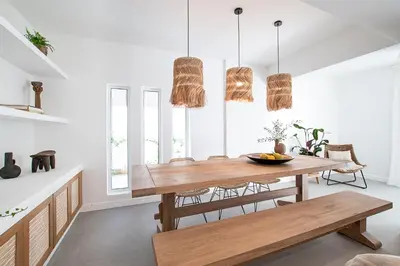 a dining room with a wooden table and chairs at LazySun in Sounio