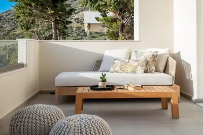 a living room with a couch and a coffee table at LazySun in Sounio