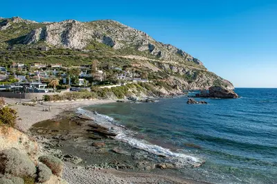 a view of a beach with houses and the ocean at LazySun in Sounio