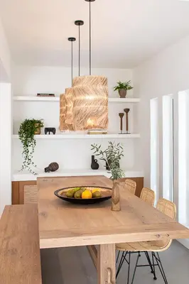 a dining room table with a bowl of fruit on it at LazySun in Sounio