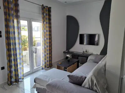 a living room with a couch and a table at Jenny's Dream Home -Acropolis Lux 2 Bedroom Apt, with Hot Tub, free Netflix, fast Wifi in Athens