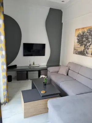 a living room with a couch and a table at Jenny's Dream Home -Acropolis Lux 2 Bedroom Apt, with Hot Tub, free Netflix, fast Wifi in Athens
