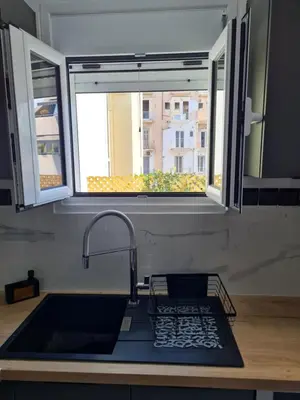 a kitchen with a sink and a window and a sink at Jenny's Dream Home -Acropolis Lux 2 Bedroom Apt, with Hot Tub, free Netflix, fast Wifi in Athens