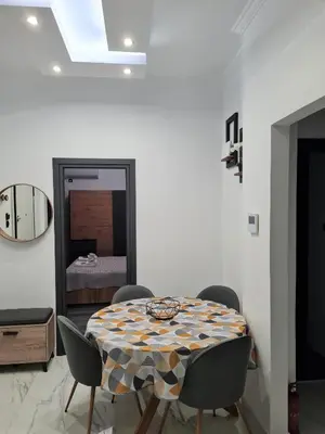 a dining room with a table and chairs and a bedroom at Jenny's Dream Home -Acropolis Lux 2 Bedroom Apt, with Hot Tub, free Netflix, fast Wifi in Athens