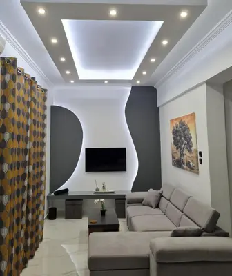 a living room with a couch and a tv at Jenny's Dream Home -Acropolis Lux 2 Bedroom Apt, with Hot Tub, free Netflix, fast Wifi in Athens
