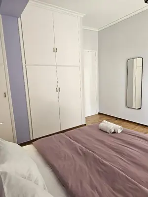 a bedroom with a large bed and a mirror at Modern Garden View Apt in Voula, Athens - Luxe in Athens