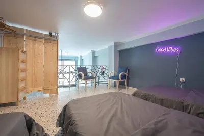 a bedroom with two beds and a neon sign on the wall at Athens Loft in Athens