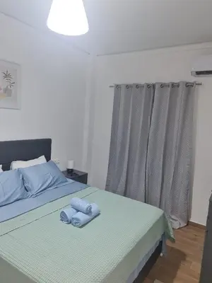 a bedroom with a bed with blue towels on it at Luxury apartment in Sepolia in Athens