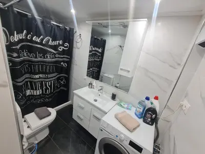 a bathroom with a sink and a toilet and a mirror at Luxury apartment in Sepolia in Athens