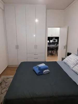 a bedroom with a bed with a blue towel on it at Luxury apartment in Sepolia in Athens
