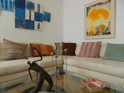 a living room with a couch and a statue at Elegant 3BD apartment in Kolonaki in Athens