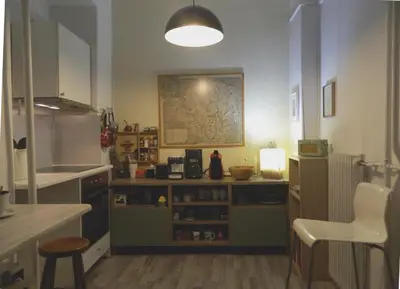 a kitchen with a counter and a table and a chair at Elegant 3BD apartment in Kolonaki in Athens