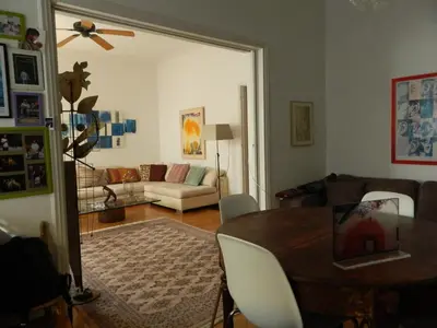 a living room with a table and a couch at Elegant 3BD apartment in Kolonaki in Athens