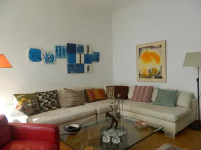 a living room with a couch and a glass table at Elegant 3BD apartment in Kolonaki in Athens