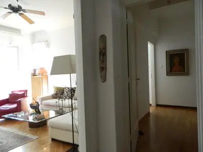 a living room with a couch and a ceiling fan at Elegant 3BD apartment in Kolonaki in Athens